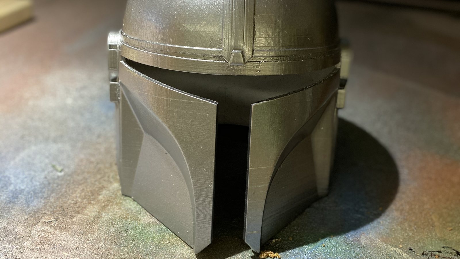 Casque de cosplay de chasseur de primes imprimé en 3D en filament argenté, lignes de couches visibles sur la visière